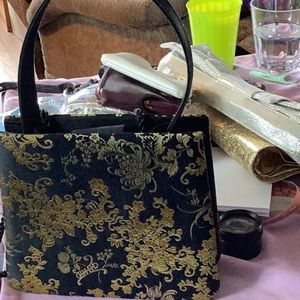 Purse . Black and gold  design . Very dressy .
